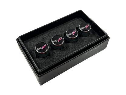 three black cufflinks in a black box