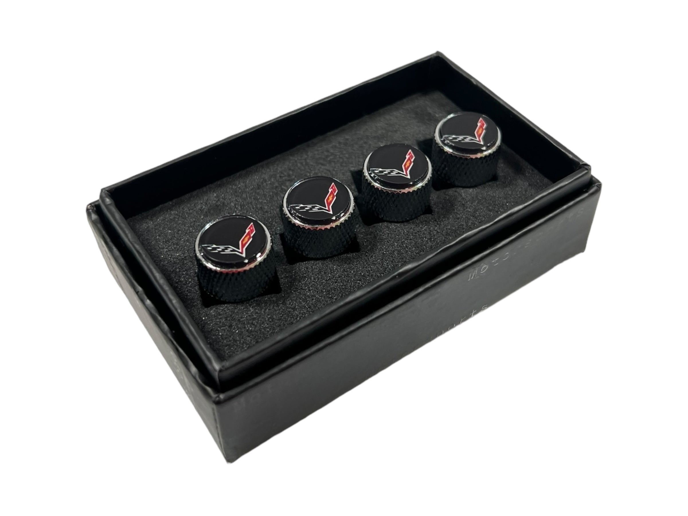 three black cufflinks in a black box