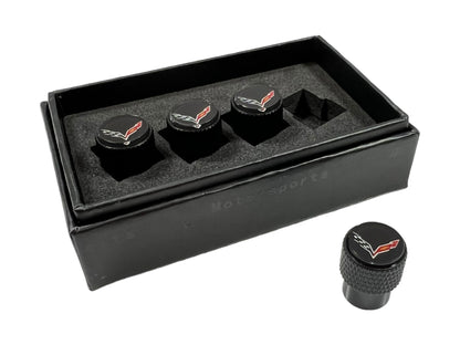 a set of four black knobs in a black case