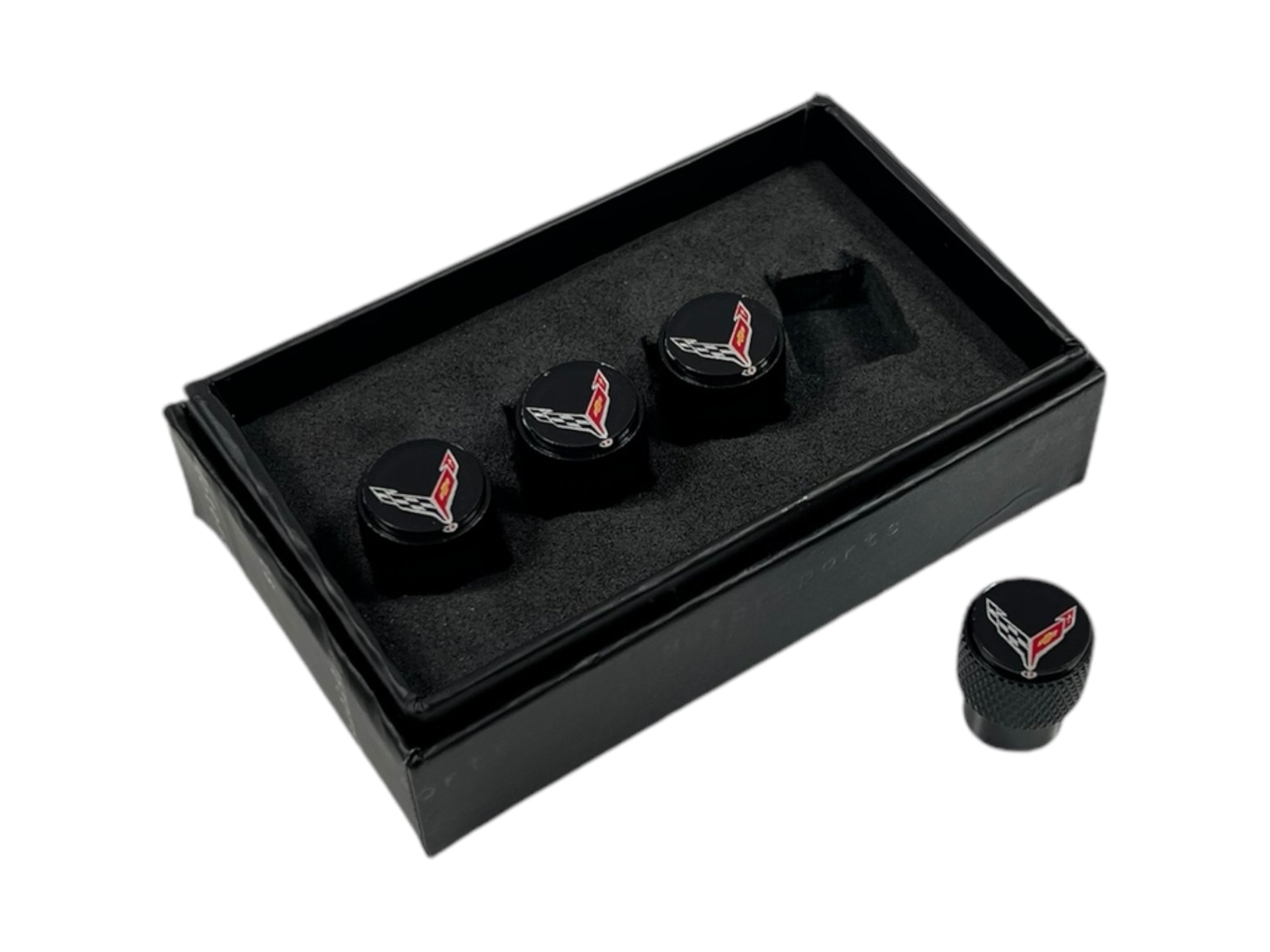 a set of three black cufflinks in a black box