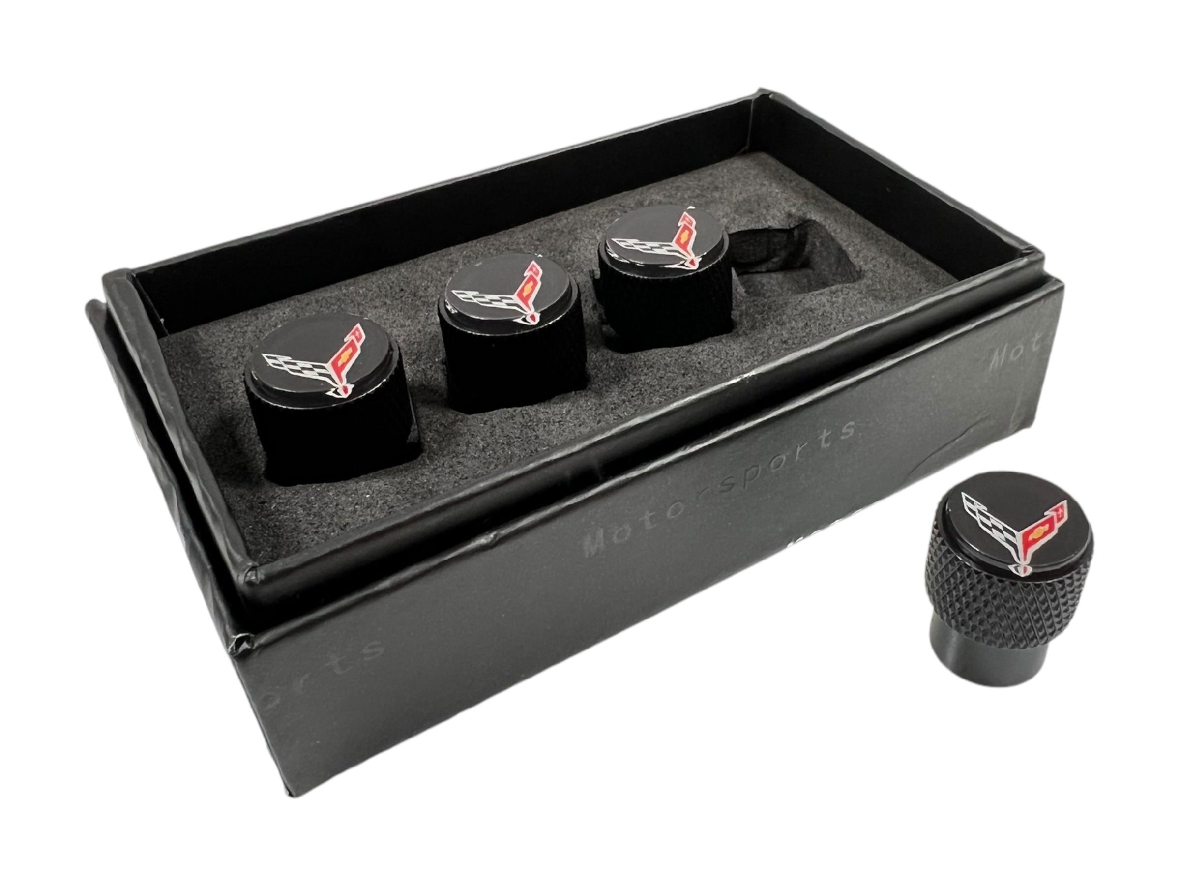 a set of four black knobs in a black box