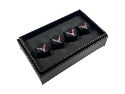 three black cufflinks in a black box