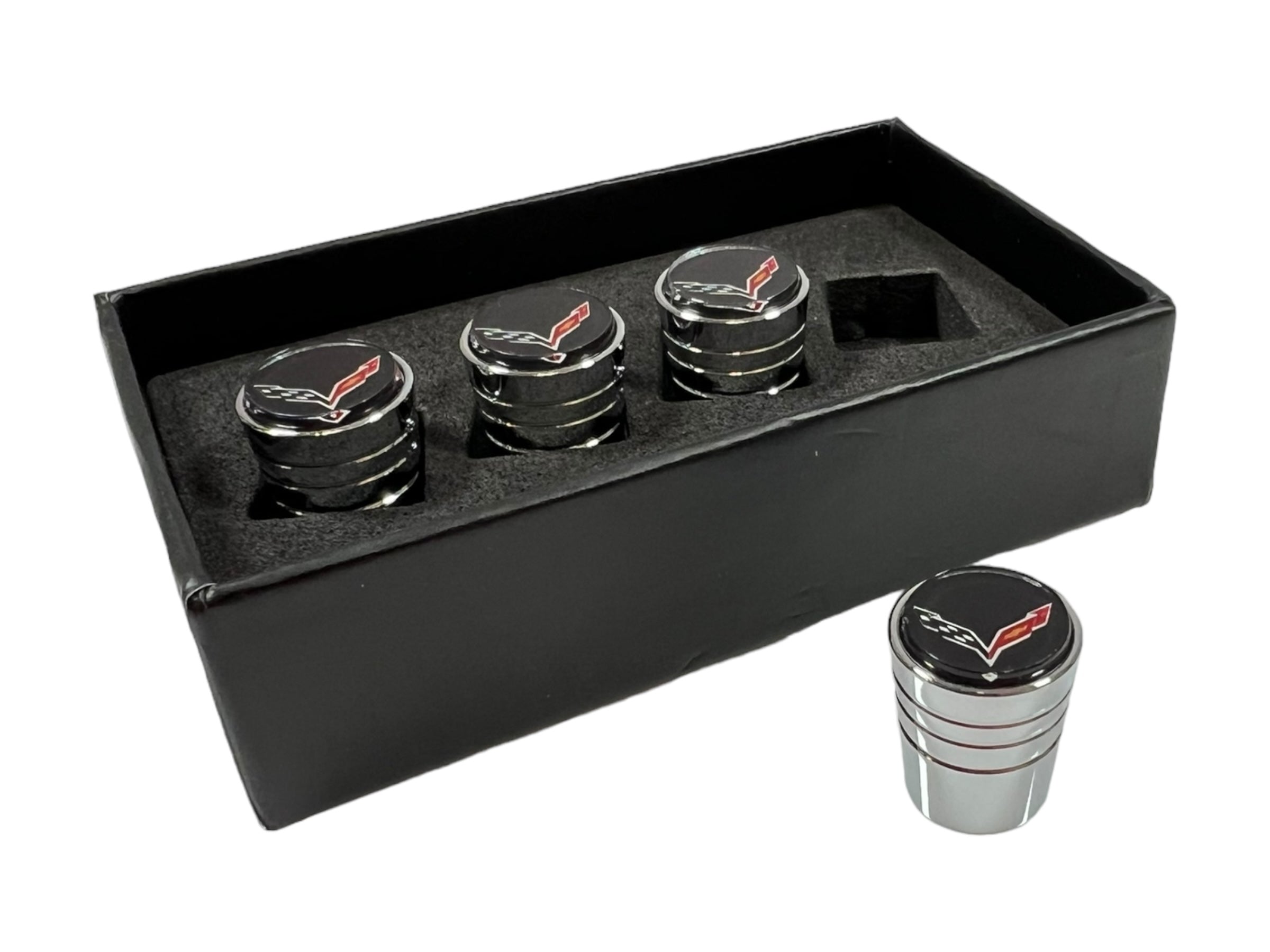 a set of four black and silver coasters in a black box