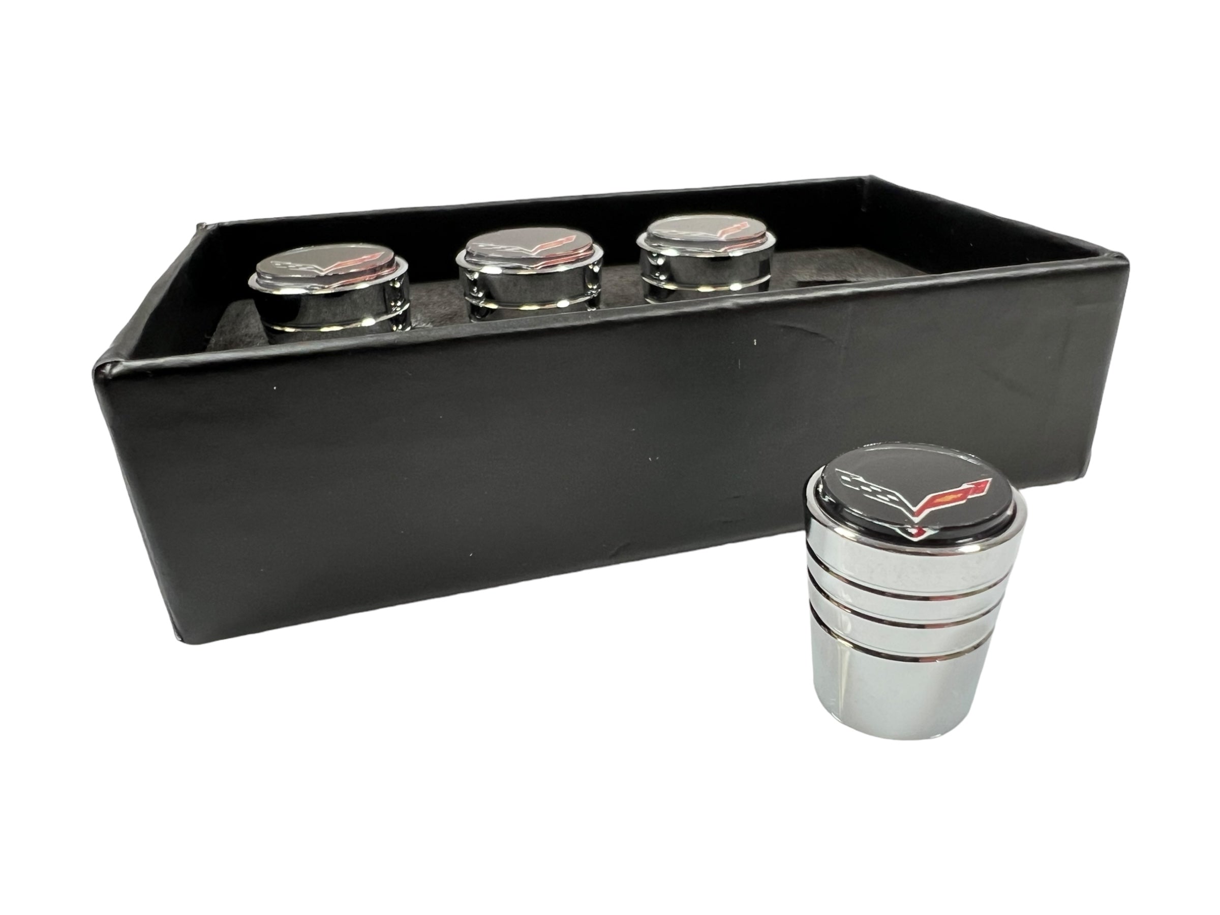 a set of four metal cups and a black case