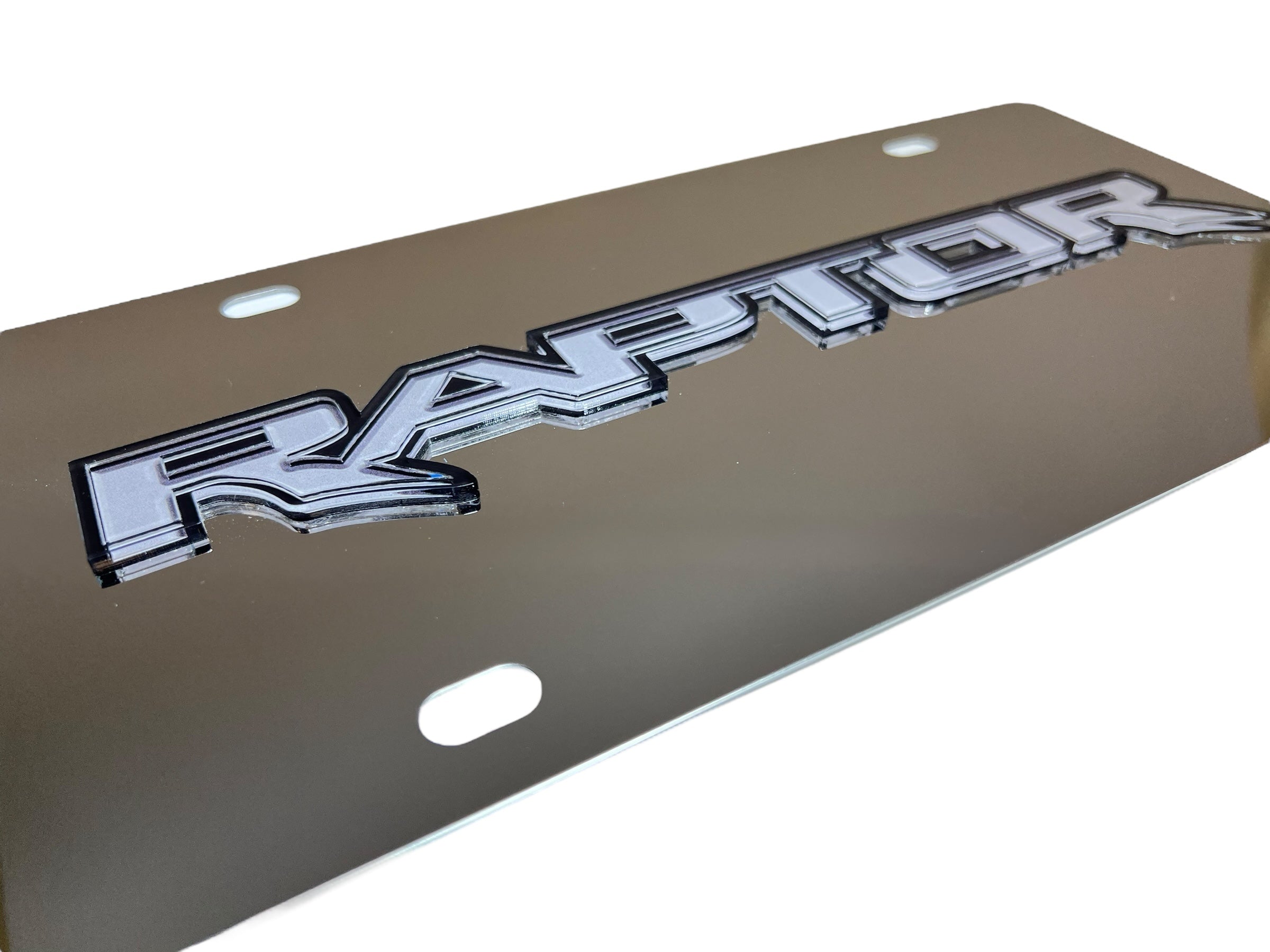 a metal license plate with the word raptor on it