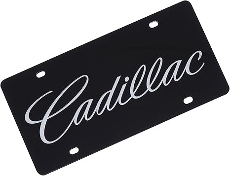 a black license plate with the word cadillac on it