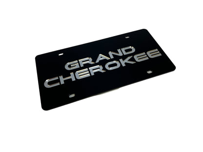 a black license plate with the words grand cherokee on it