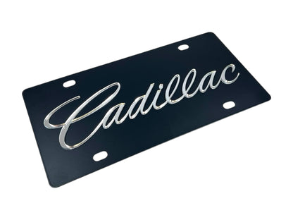 a black license plate with the word cadillac on it