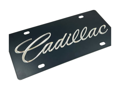 a black license plate with the word cadillac on it