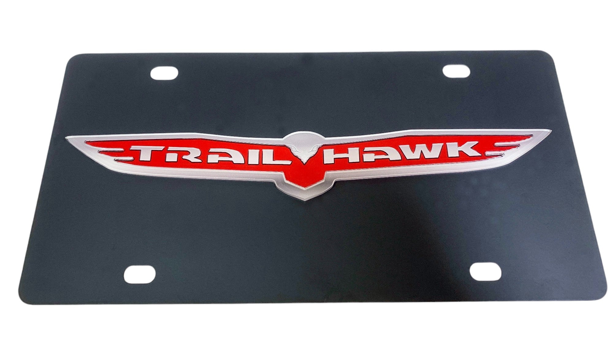 a metal license plate with the word trail hawk on it