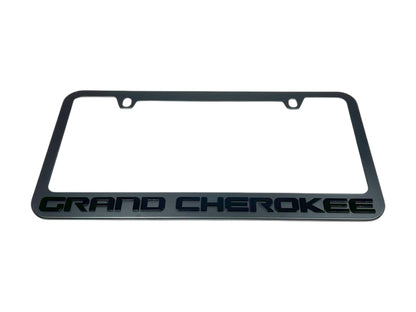 a black license plate frame with the word grand cheroke