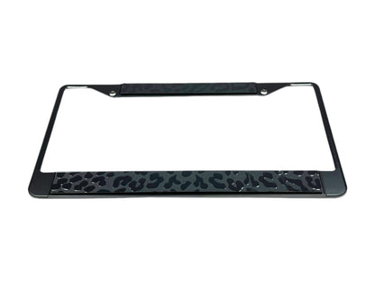 a metal license plate frame with a leopard print