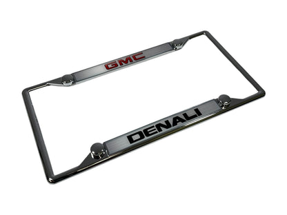 a chrome license plate frame with the gmc logo