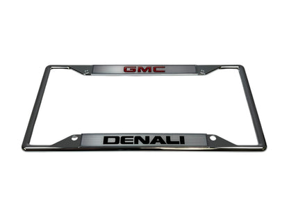 a chrome license plate frame with the gmc logo