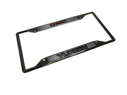 a chrome license plate frame with the word gmc on it