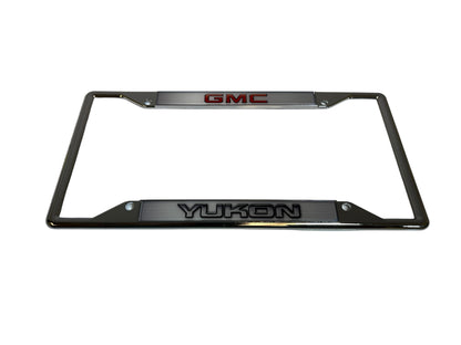 a chrome license plate frame with the gmc logo