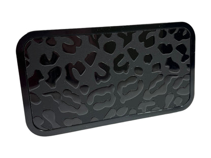 a black tray with a pattern of hearts on it