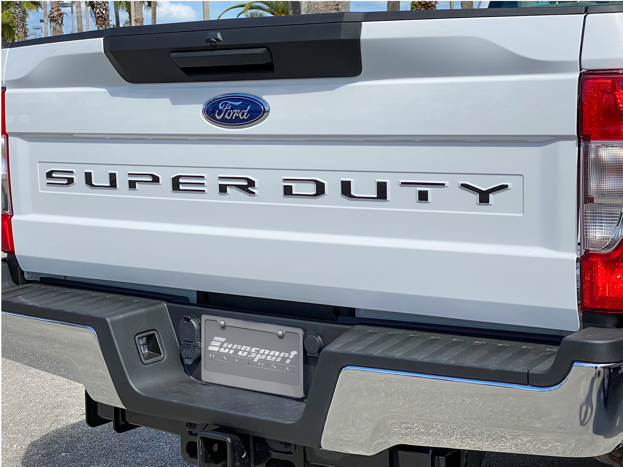 a white super duty truck parked in a parking lot