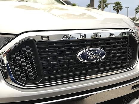 the front grille of a white ford ranger