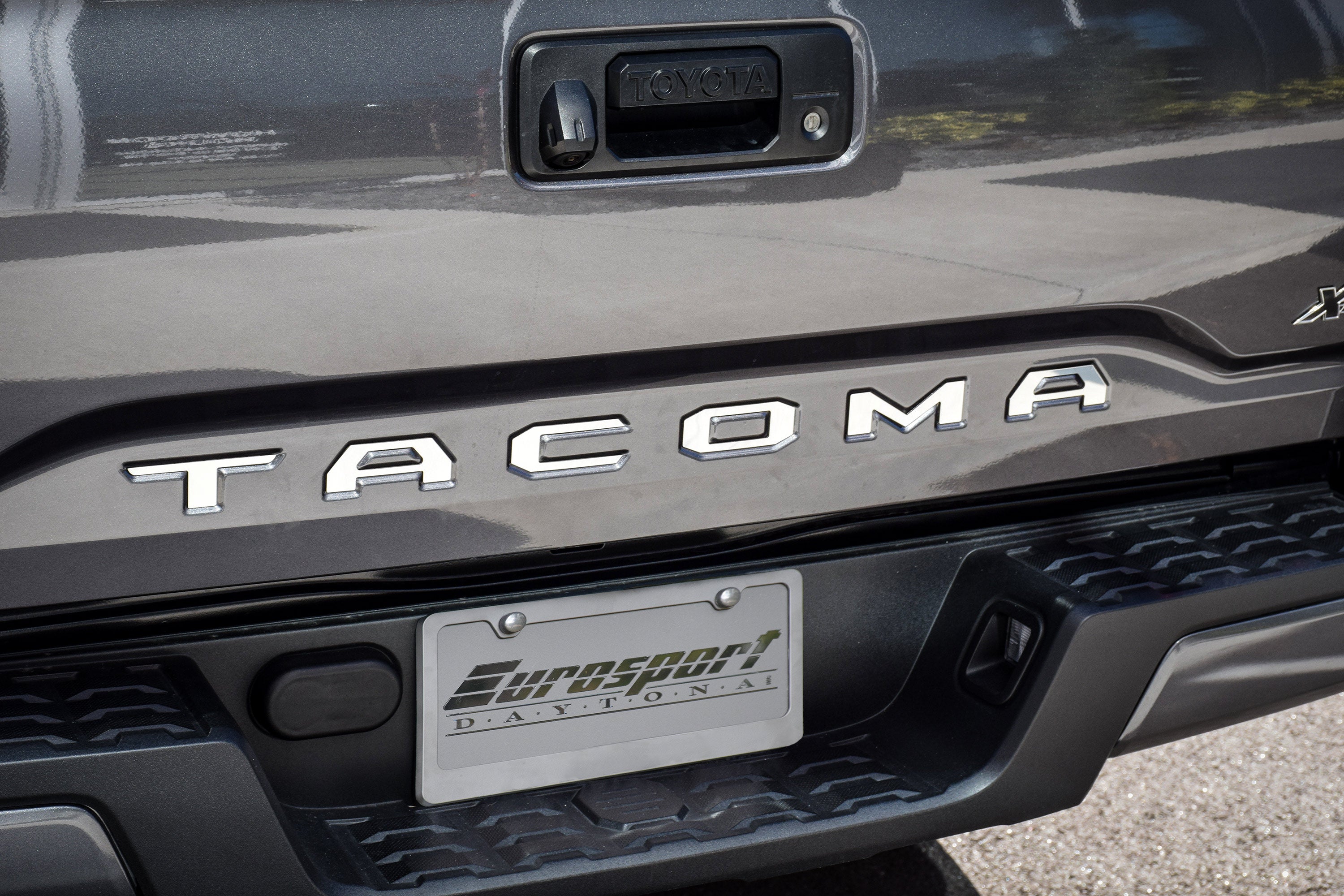 a close up of the tacoma badge on the back of a truck