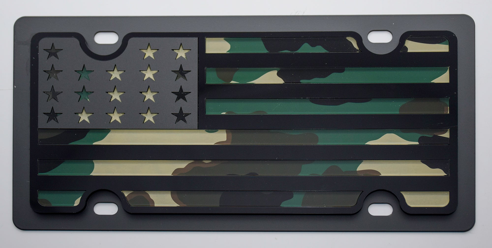 a camo american flag license plate on a white background