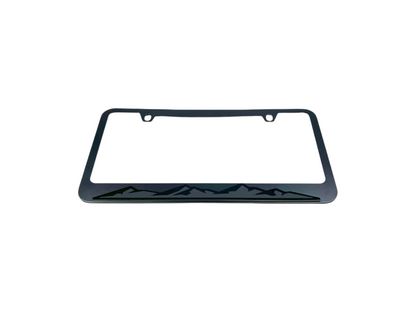 a black license plate frame with mountains on it